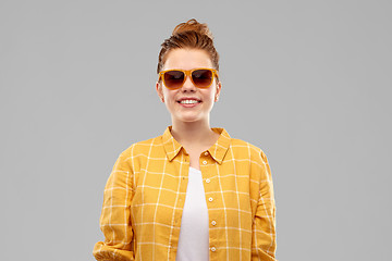 Image showing smiling red haired teenage girl in sunglasses