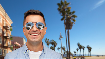 Image showing smiling man in sunglasses over venice beach