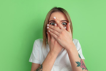 Image showing Caucasian young woman\'s portrait on green studio background