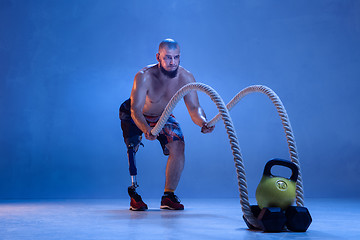 Image showing Athlete disabled amputee isolated on blue studio background