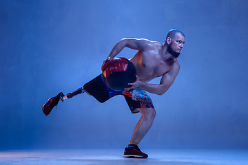 Image showing Athlete disabled amputee isolated on blue studio background