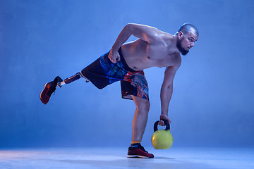 Image showing Athlete disabled amputee isolated on blue studio background