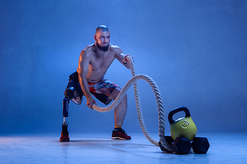 Image showing Athlete disabled amputee isolated on blue studio background