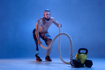 Image showing Athlete disabled amputee isolated on blue studio background