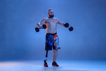 Image showing Athlete disabled amputee isolated on blue studio background