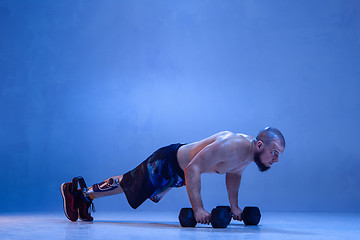 Image showing Athlete disabled amputee isolated on blue studio background