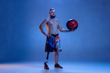 Image showing Athlete disabled amputee isolated on blue studio background