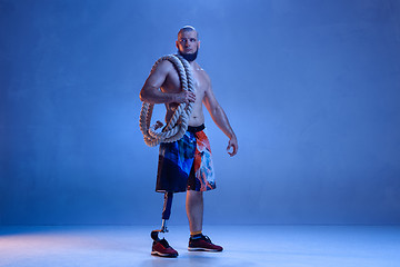 Image showing Athlete disabled amputee isolated on blue studio background