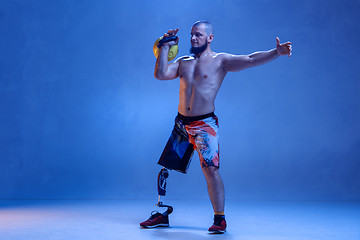 Image showing Athlete disabled amputee isolated on blue studio background