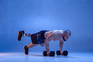 Image showing Athlete disabled amputee isolated on blue studio background