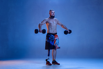 Image showing Athlete disabled amputee isolated on blue studio background