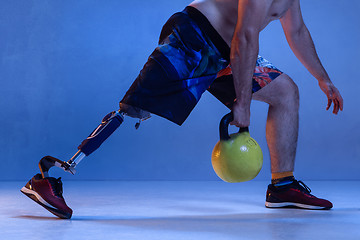 Image showing Athlete disabled amputee isolated on blue studio background