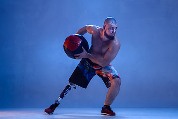 Image showing Athlete disabled amputee isolated on blue studio background