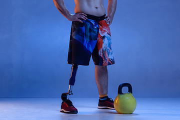 Image showing Athlete disabled amputee isolated on blue studio background