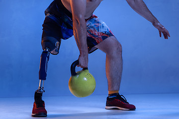 Image showing Athlete disabled amputee isolated on blue studio background