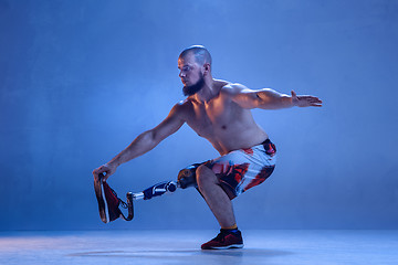 Image showing Athlete disabled amputee isolated on blue studio background