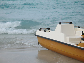 Image showing yellow paddle boat on the ocean