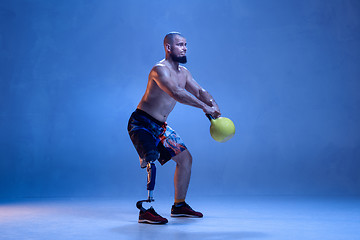 Image showing Athlete disabled amputee isolated on blue studio background