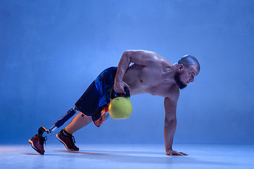 Image showing Athlete disabled amputee isolated on blue studio background