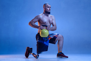 Image showing Athlete disabled amputee isolated on blue studio background