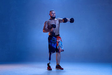 Image showing Athlete disabled amputee isolated on blue studio background