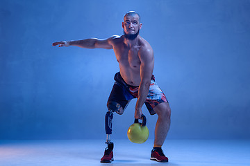 Image showing Athlete disabled amputee isolated on blue studio background