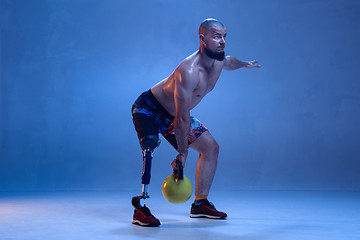 Image showing Athlete disabled amputee isolated on blue studio background