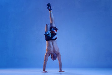 Image showing Athlete disabled amputee isolated on blue studio background