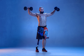 Image showing Athlete disabled amputee isolated on blue studio background