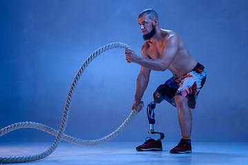 Image showing Athlete disabled amputee isolated on blue studio background