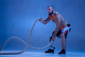 Image showing Athlete disabled amputee isolated on blue studio background