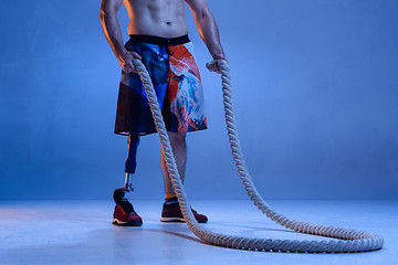 Image showing Athlete disabled amputee isolated on blue studio background