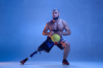 Image showing Athlete disabled amputee isolated on blue studio background