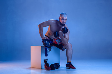 Image showing Athlete disabled amputee isolated on blue studio background