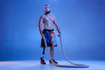 Image showing Athlete disabled amputee isolated on blue studio background