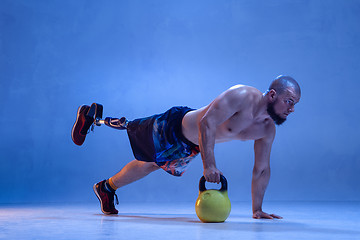 Image showing Athlete disabled amputee isolated on blue studio background