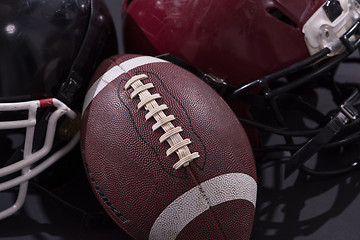 Image showing american football and helmets isolated on gray