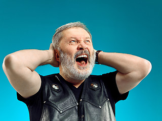 Image showing Smiling middle-aged man happy expression posing in front of a blue background with copy space