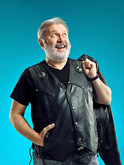 Image showing Smiling middle-aged man happy expression posing in front of a blue background with copy space