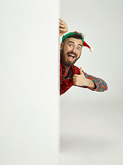 Image showing friendly man dressed like a funny gnome posing on an isolated gray background