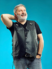 Image showing Smiling middle-aged man happy expression posing in front of a blue background with copy space