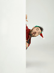 Image showing friendly man dressed like a funny gnome posing on an isolated gray background