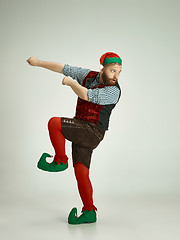 Image showing friendly man dressed like a funny gnome posing on an isolated gray background