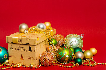 Image showing Christmas decoration gift box with red background