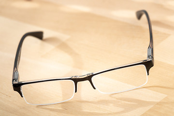 Image showing reading glasses on a wooden table