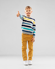 Image showing smiling boy in striped pullover showing thumbs up