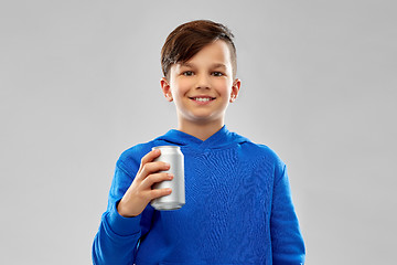 Image showing smiling boy in blue hoodie holding can drink