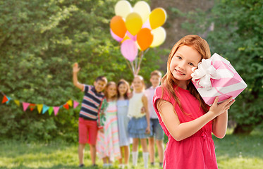 Image showing lovely red haired girl with birthday gift at party