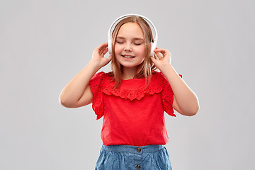 Image showing smiling girl in headphones listening to music