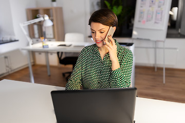 Image showing businesswoman calling on smartphone at office